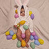 baby, blanket, bunny_costume, child, colorful, cute, easter_eggs, festive, headwear, holiday_theme, indoors, infant, legs, lying_down, plastic_eggs, portrait, small_feet, soft_texture, toy, white_clothing