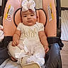 baby, bow, car_seat, child, cute, floor, footwear, headband, holiday, indoors, infant, person, pink, portrait, seated, tutu, warning_label, white_clothing, wooden_floor, young_child