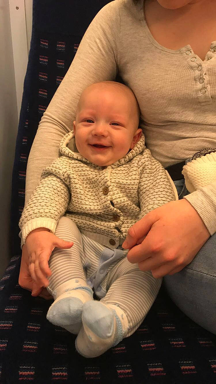 Bertie is registered to the contest to win money with this photo: arm, baby, child, finger, hand, joy, knitting, person, sitting, skin, thumb, toddler, wool