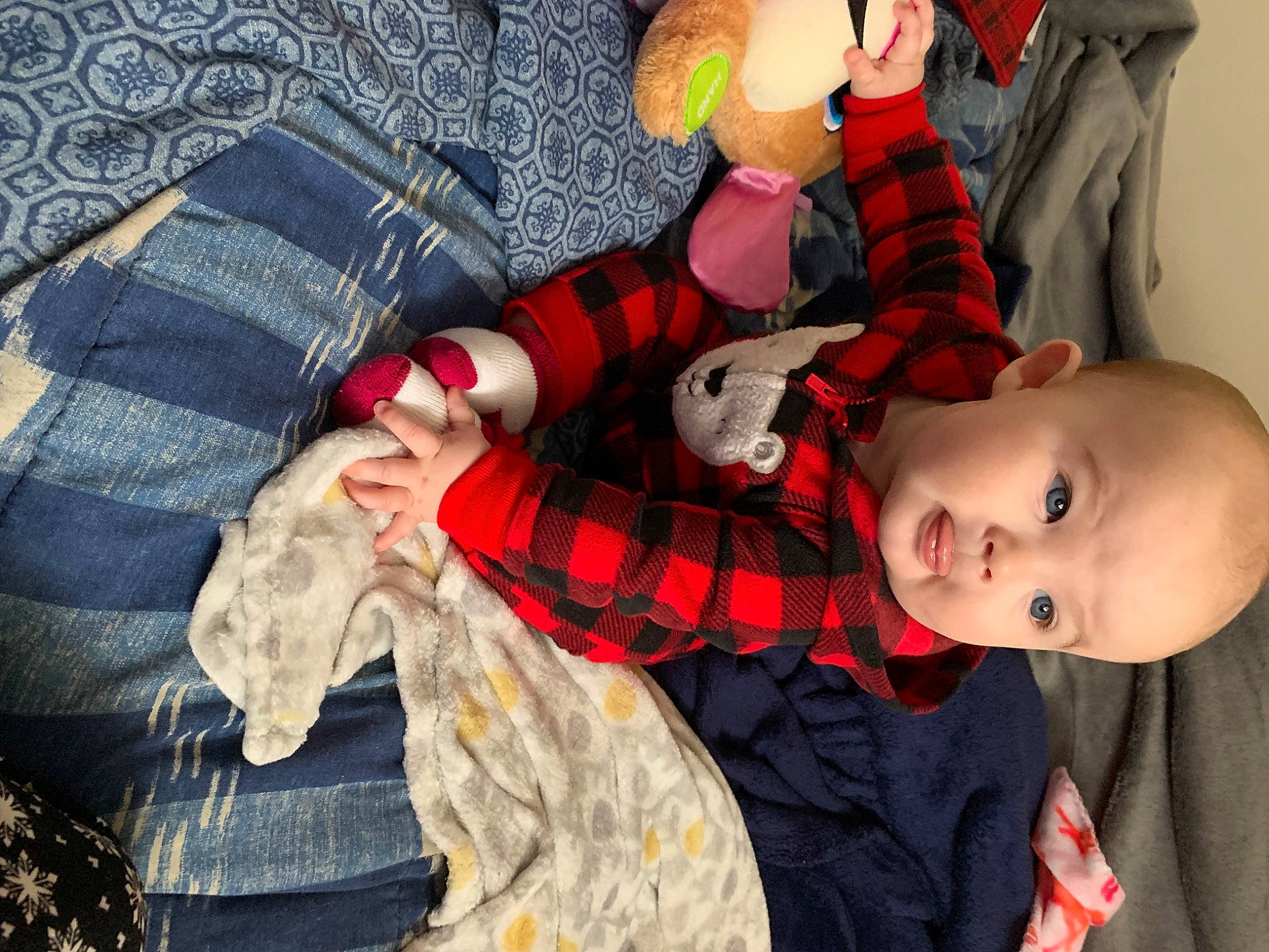 Everly is registered to the contest to win money with this photo: baby, baby_products, baby_toddler_clothing, bed, carmine, child, comfort, doll, linens, nail, pattern, person, plaid, room, sock, stuffed_toy, tartan, textile, toddler, toy