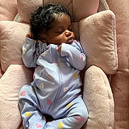 Leilani joined the competition — help win amazing prizes! baby, sleeping, onesie, blue_clothing, pastel_colors, plush_cushion, pink, infant, cute, peaceful, indoor, soft_texture, cozy, child, newborn, resting, face, person, comfort, relaxation