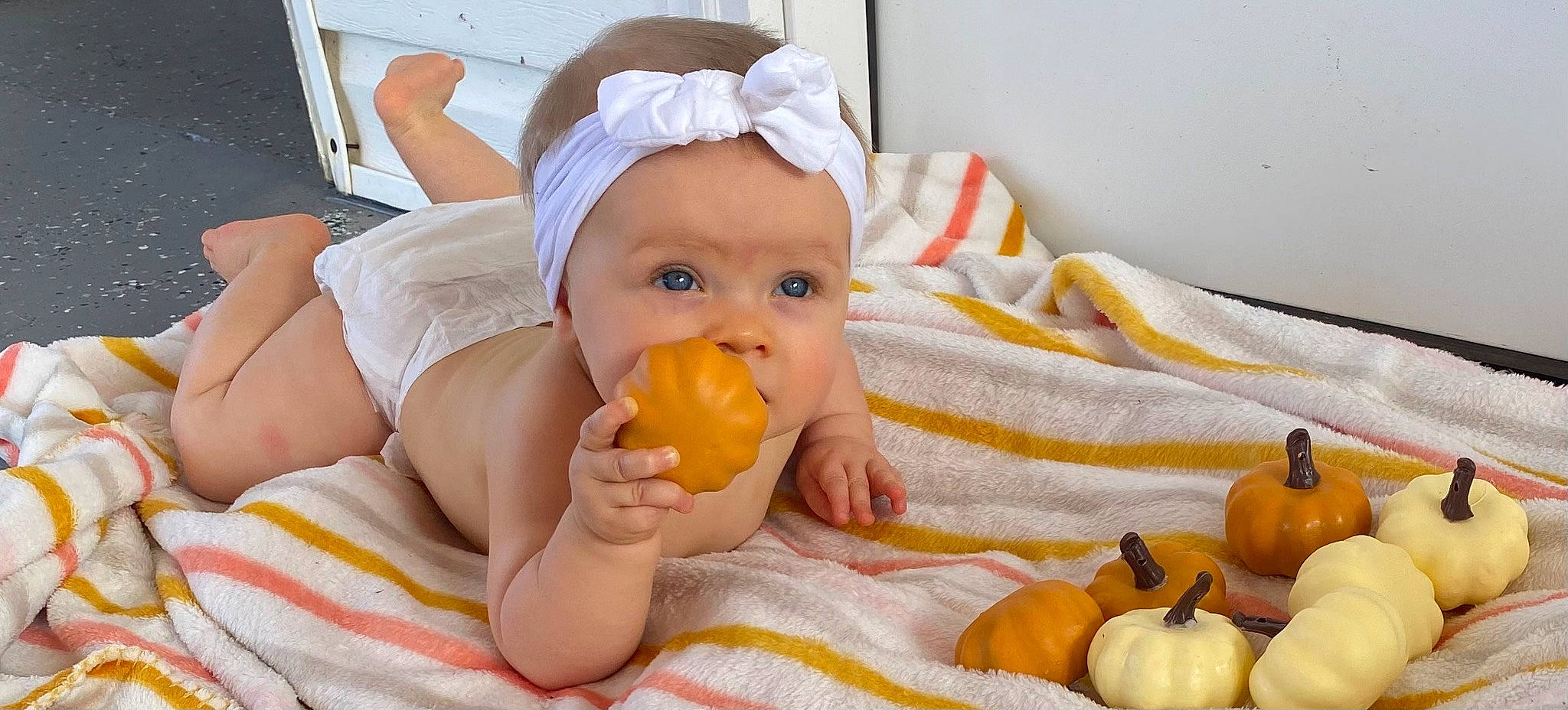Aubrey is registered to the contest to win money with this photo: baby, baby_products, baby_toddler_clothing, bathing, cheek, child, comfort, drinkware, facial_expression, fun, happy, headwear, mouth, orange, person, room, sitting, skin, tableware, thumb