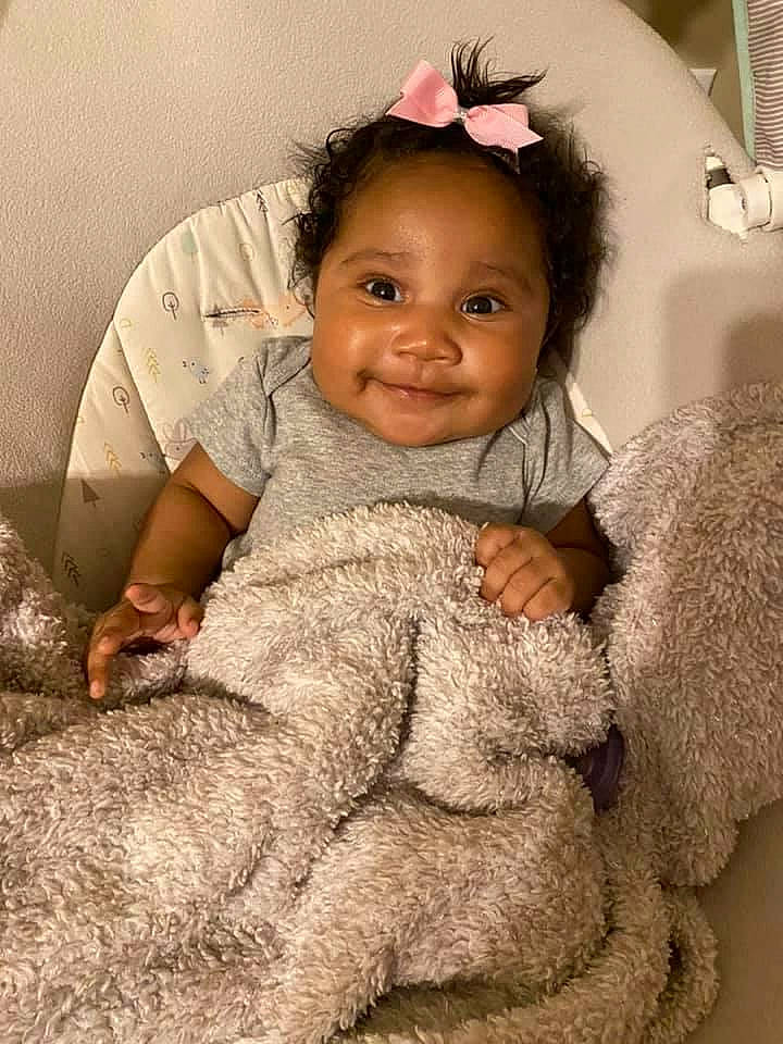 Emani is registered to the contest to win money with this photo: baby, baby_toddler_clothing, child, comfort, costume_accessory, fur, hair_accessory, headband, headpiece, joy, knitting, person, pink, plush, stuffed_toy, textile, toddler, wool, woolen