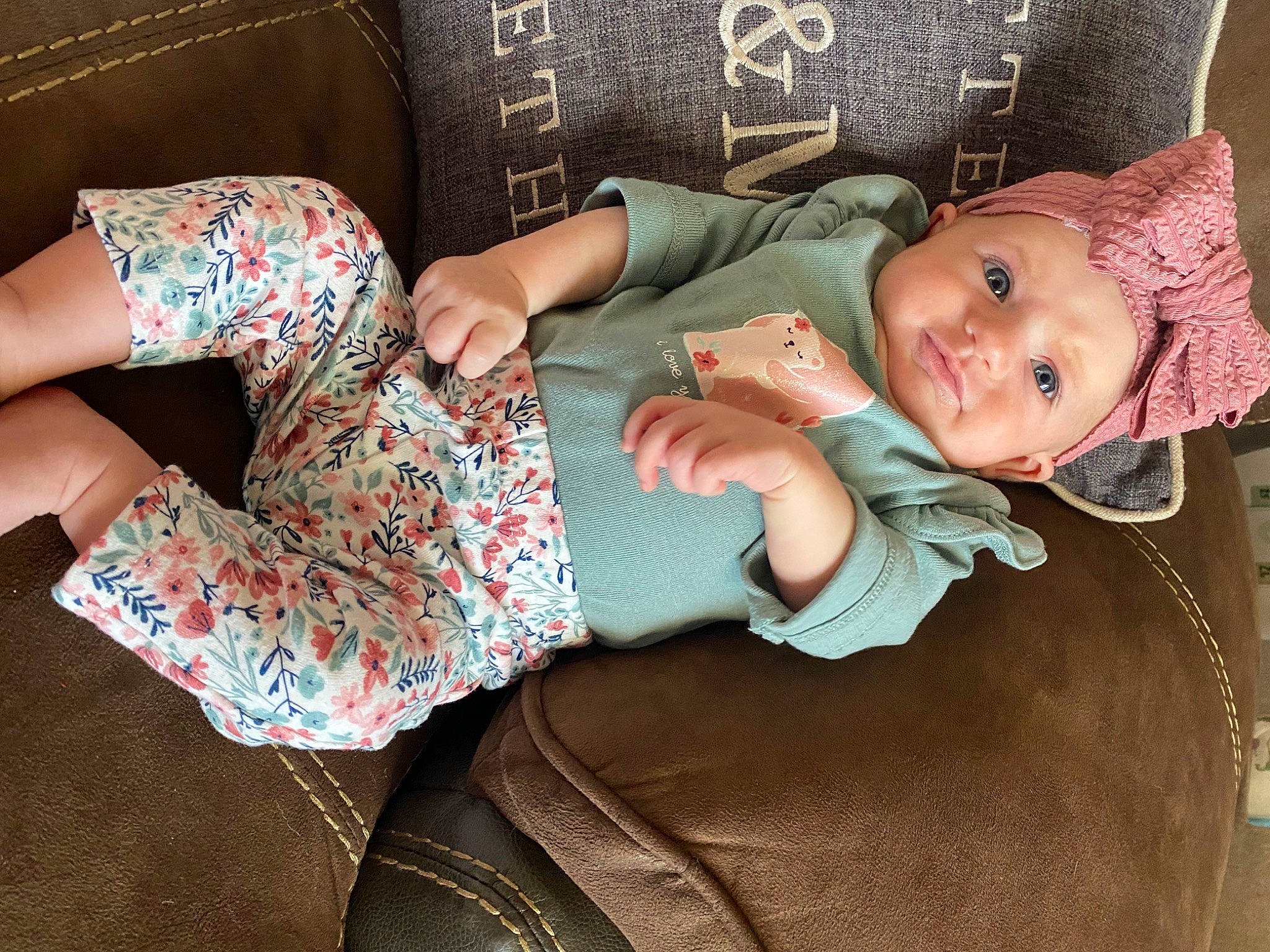Kinzley joined the competition — help win amazing prizes! arm, baby, baby_toddler_clothing, child, comfort, dress, finger, hand, headgear, headwear, human_body, human_leg, lap, pattern, person, pink, skin, sleeve, smile, textile
