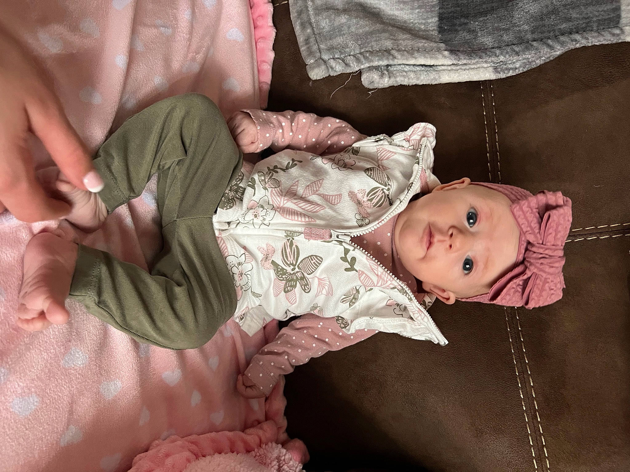 Kinzley is registered to the contest to win money with this photo: arm, baby, baby_toddler_clothing, camouflage, cheek, comfort, eye, facial_expression, hand, head, human_body, leg, mammal, military_camouflage, mouth, person, product, skin, sleeve, textile