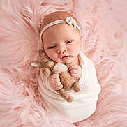 Aurora is registered to the contest to win money with this photo: baby, newborn, infant, wrapped, blanket, stuffed_toy, bunny, plush, pink, soft, fluffy, headband, cute, sleepy, child, portrait, indoors, hands, face, cozy
