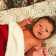 Eric joined the competition — help win amazing prizes! baby, newborn, blanket, red, white, crochet, fabric, pine_branch, snow, holiday, christmas, infant, skin, face, arm, hand, lying_down, cozy, cute, portrait