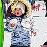toddler, child, snowball, winter_clothing, hood, hat, outdoor, snow, cold_weather, curious, rosy_cheeks, winter_jacket, playful, person, daylight, people, nature, fun, seasonal, portrait