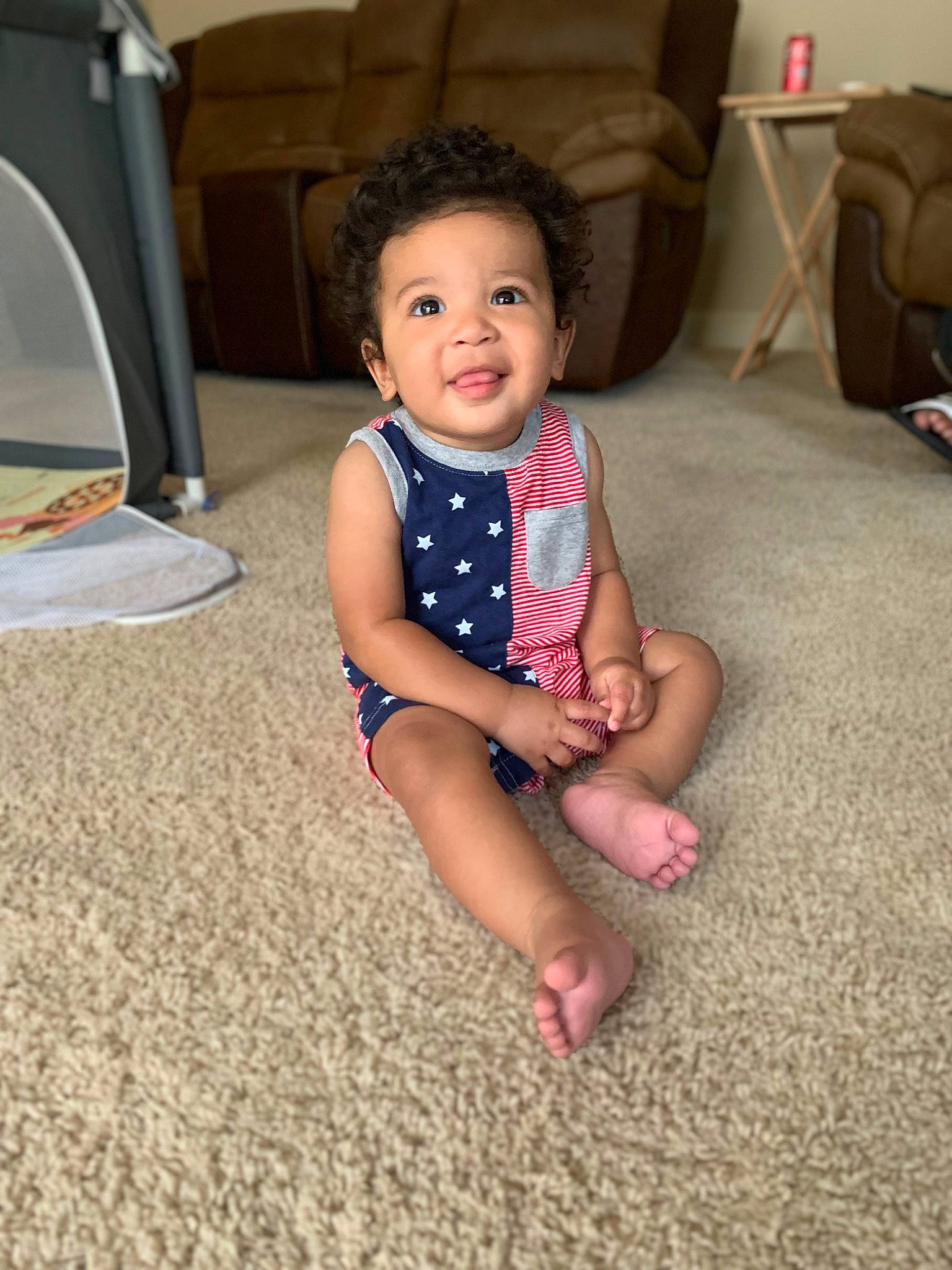 Leon is registered to the contest to win money with this photo: baby_toddler_clothing, barefoot, child, comfort, eye, face, finger, floor, flooring, foot, fun, happy, head, human_leg, leg, living_room, person, skin, smile, thigh
