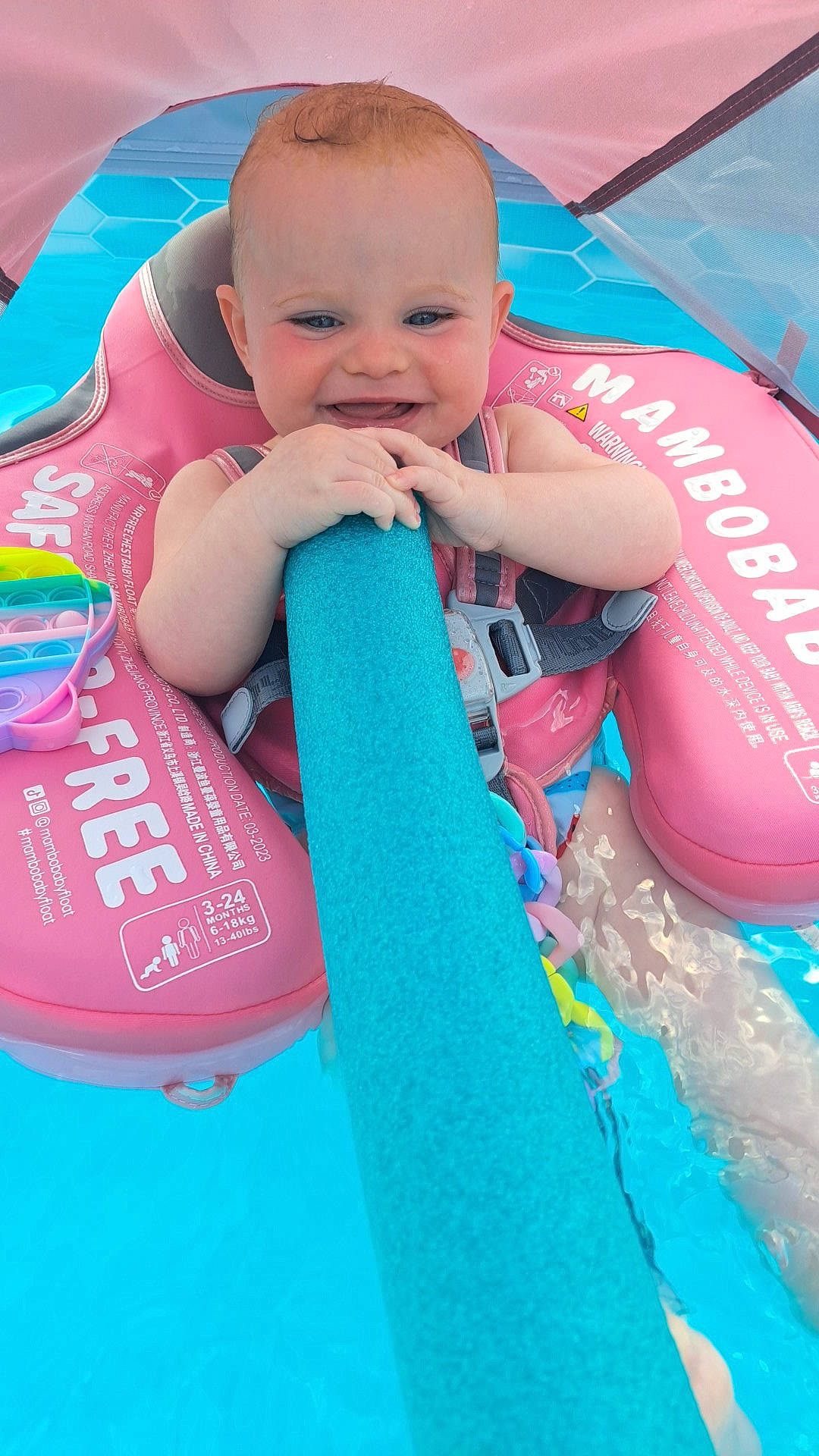 Ansley is registered to the contest to win money with this photo: aqua, azure, baby, baby_products, baby_toddler_clothing, blue, child, electric_blue, face, fun, happy, joy, leisure, person, pink, play, recreation, skin, smile, toddler