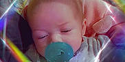 Arianna is registered to the contest to win money with this photo: baby, pacifier, infant, sleeping, soft_focus, rainbow_light, kaleidoscope, duplicate, cute, child, pastel_colors, blanket, closeup, face, indoors, adorable, peaceful, soft_lighting, portrait, sleepy