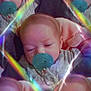 baby, pacifier, infant, sleeping, soft_focus, rainbow_light, kaleidoscope, duplicate, cute, child, pastel_colors, blanket, closeup, face, indoors, adorable, peaceful, soft_lighting, portrait, sleepy