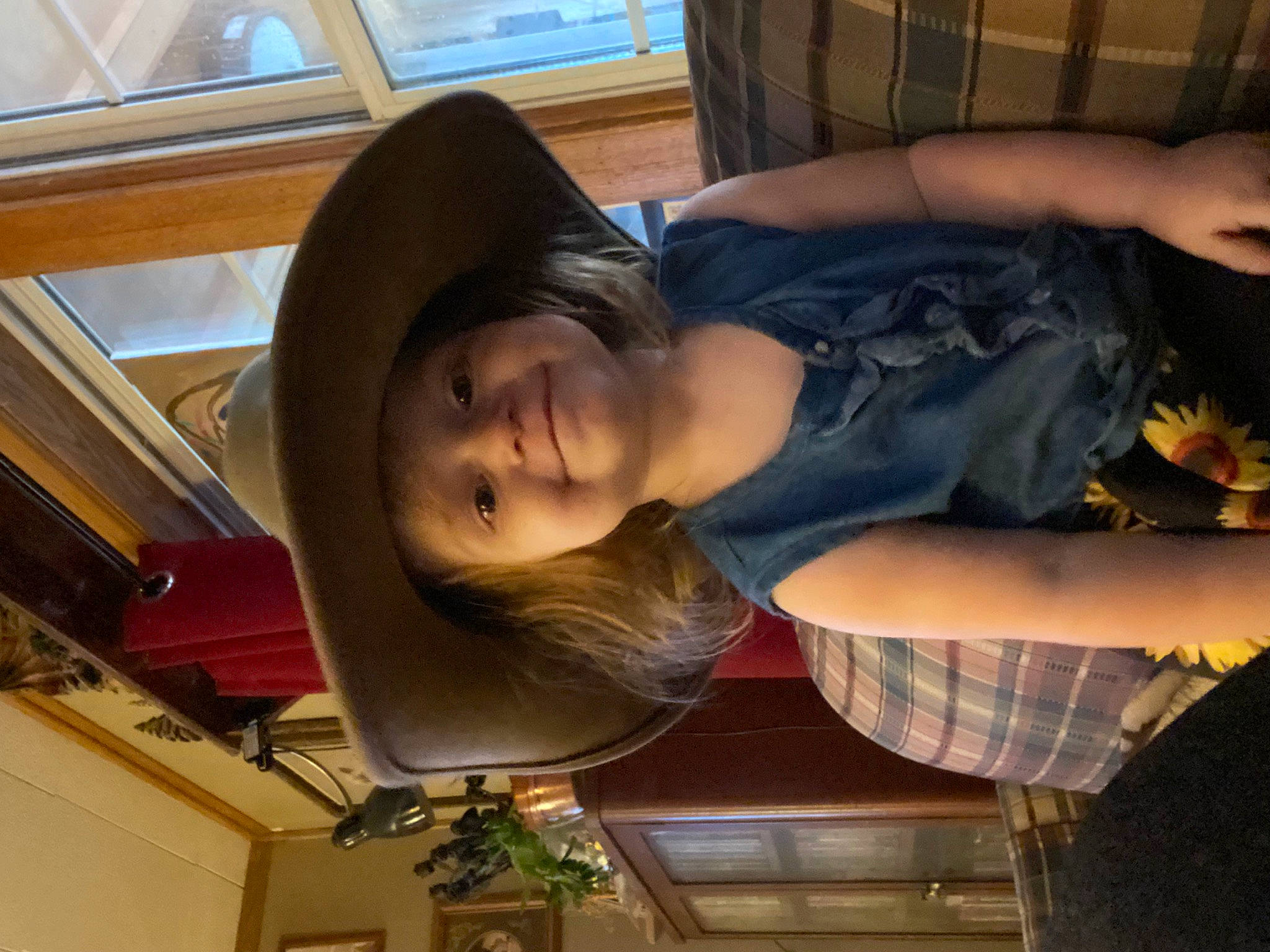 Camryn is registered to the contest to win money with this photo: chin, elbow, fashion_accessory, fun, hat, headwear, houseplant, human_leg, joy, leisure, mouth, person, plaid, plant, smile, sun_hat, t_shirt, thigh, throat, travel