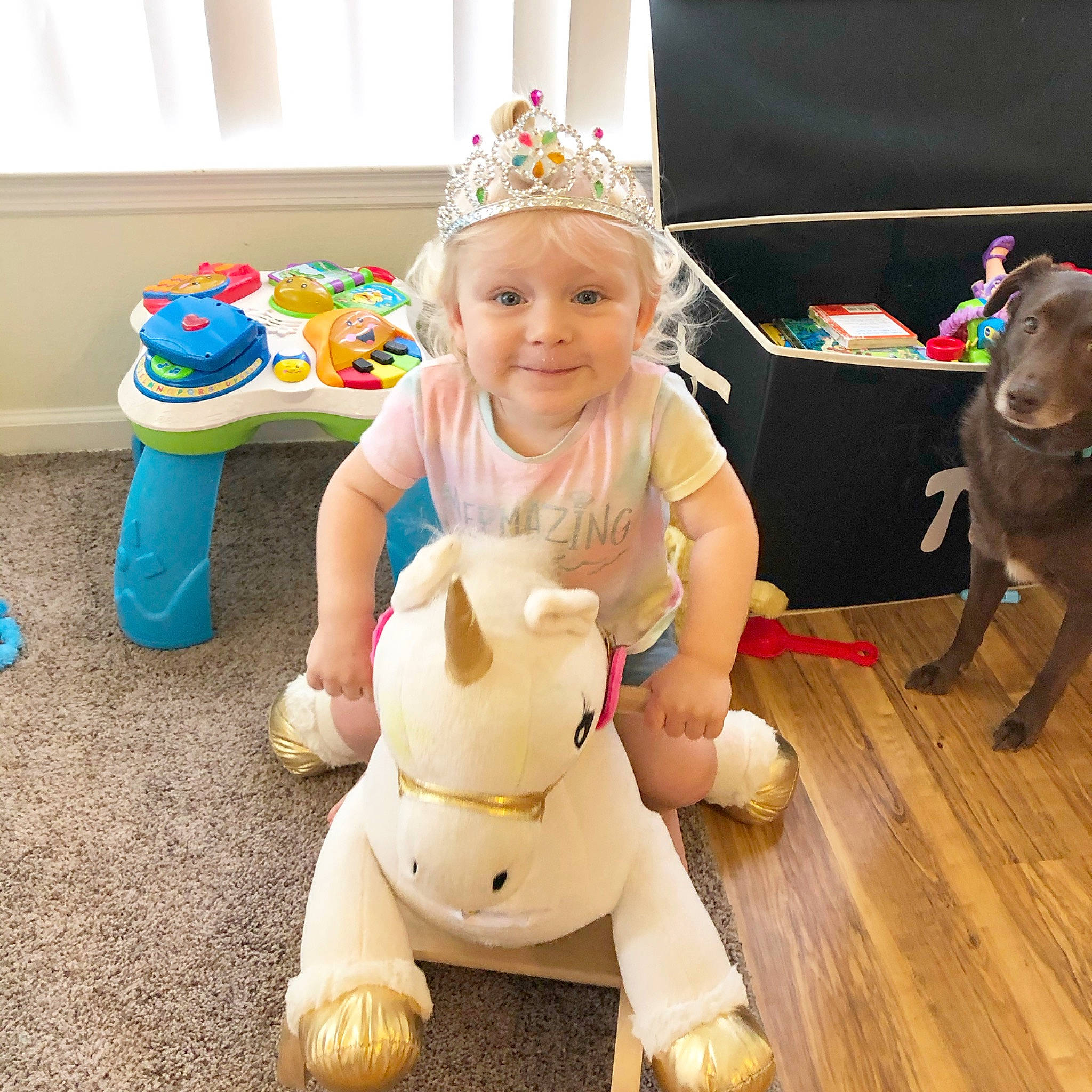 Rowan is registered to the contest to win money with this photo: child, ear, fawn, floor, flooring, happy, headwear, joy, party, person, play, sitting, toddler, toy, wood