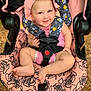 baby, bonnet, cap, car, clothing, coat, costume, face, happy, hat, head, hood, jacket, person, photography, portrait, skin, smile, stroller, tattoo