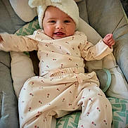 Annalise joined the competition — help win amazing prizes! baby, baby_seat, child, clothing, comfort, cushion, cute, face, fluffy, happy, hat, indoor, infant, infant_wear, pajamas, portrait, relaxing, small_person, smiling, soft