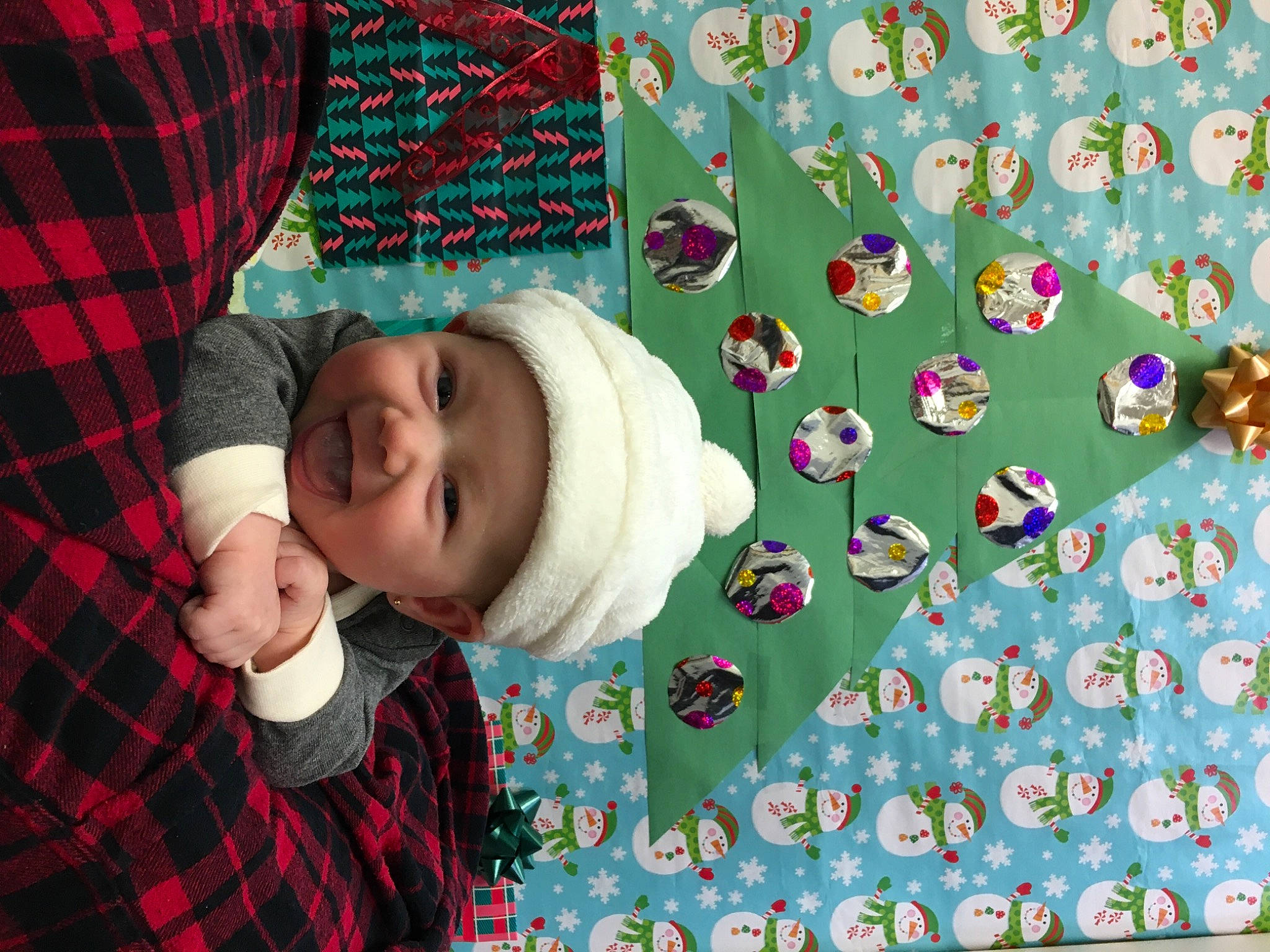 Avalynn joined the competition — help win amazing prizes! art, baby, baby_toddler_clothing, cap, child, fashion_accessory, grass, green, happy, headwear, linens, pattern, person, plaid, product, red, sleeve, tartan, textile, toddler