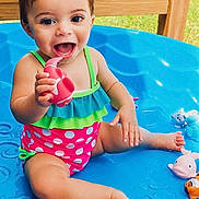 Isabella is registered to the contest to win money with this photo: baby, barefoot, blue, child, cute, fun, happy, outdoor, pink, playing, polka_dot, pool, ruffles, sitting, smiling, summer, swimsuit, toddler, toy, water