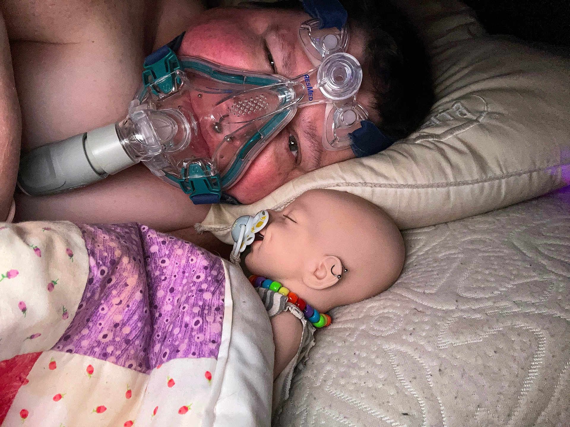 Snow Angel joined the competition — help win amazing prizes! person, baby_doll, sleeping, pacifier, cpap_mask, quilt, pillow, bed, bead_necklace, earring, close_up, indoor, blanket, resting, face, human, medical_device, comfort, intimacy, nighttime