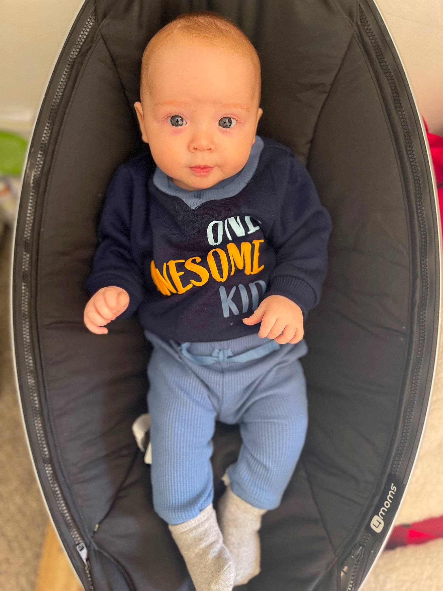Kashton is registered to the contest to win money with this photo: arm, auto_part, automotive_tire, automotive_wheel_system, baby, baby_carriage, baby_toddler_clothing, car_seat, car_seat_cover, chair, comfort, electric_blue, leg, person, rim, shoe, sleeve, sneakers, t_shirt, tire