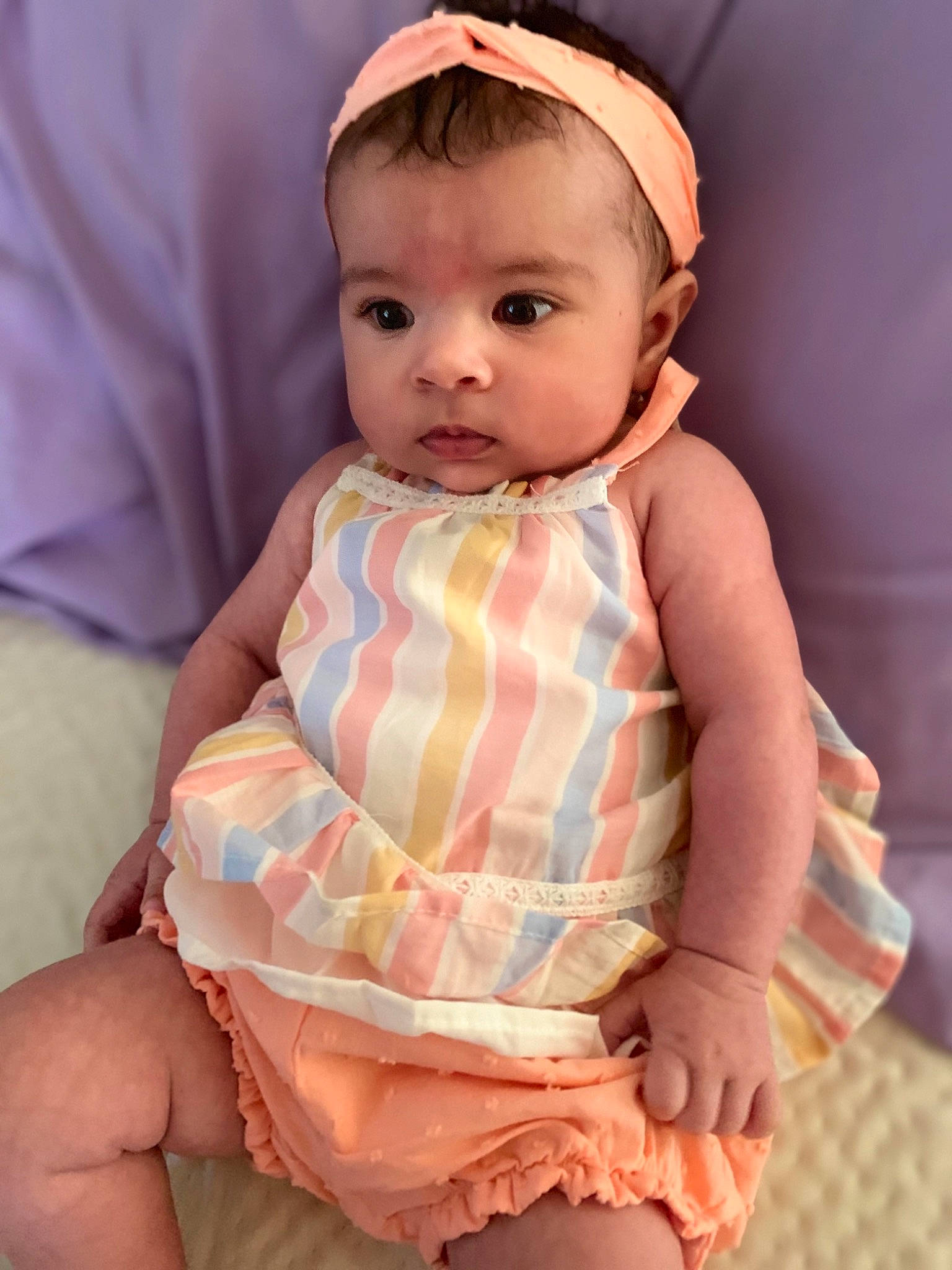 Aryah is registered to the contest to win money with this photo: baby, baby_toddler_clothing, cheek, child, dress, eye, eyelash, face, finger, head, iris, lip, neck, pattern, peach, person, pink, skin, sleeve, thumb