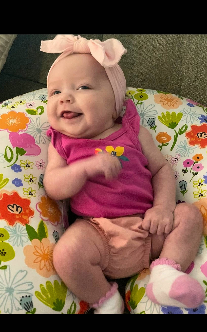Bexleigh is registered to the contest to win money with this photo: baby, baby_laughing, baby_toddler_clothing, cheek, child, comfort, finger, grass, happy, magenta, pattern, person, pink, product, purple, sitting, skin, sleeve, smile, textile