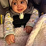 baby, child, car_seat, knit_hat, bear_ears, blanket, onesie, infant, seatbelt, cute, smile, indoors, portrait, warm_clothing, soft_texture, fuzzy_blanket, closeup, happy, small_hands, warm_light
