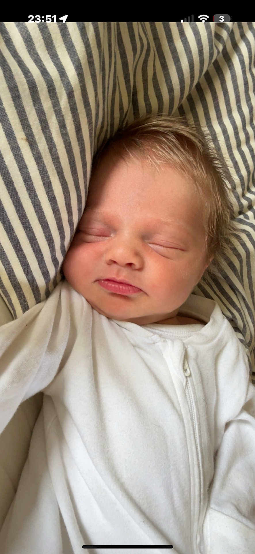 Albie joined the competition — help win amazing prizes! baby, sleeping, infant, white_clothing, striped_pillow, closeup, face, peaceful, young_child, newborn, portrait, resting, soft_lighting, indoor, child, cute, skin, head, hair, zipped_onesie