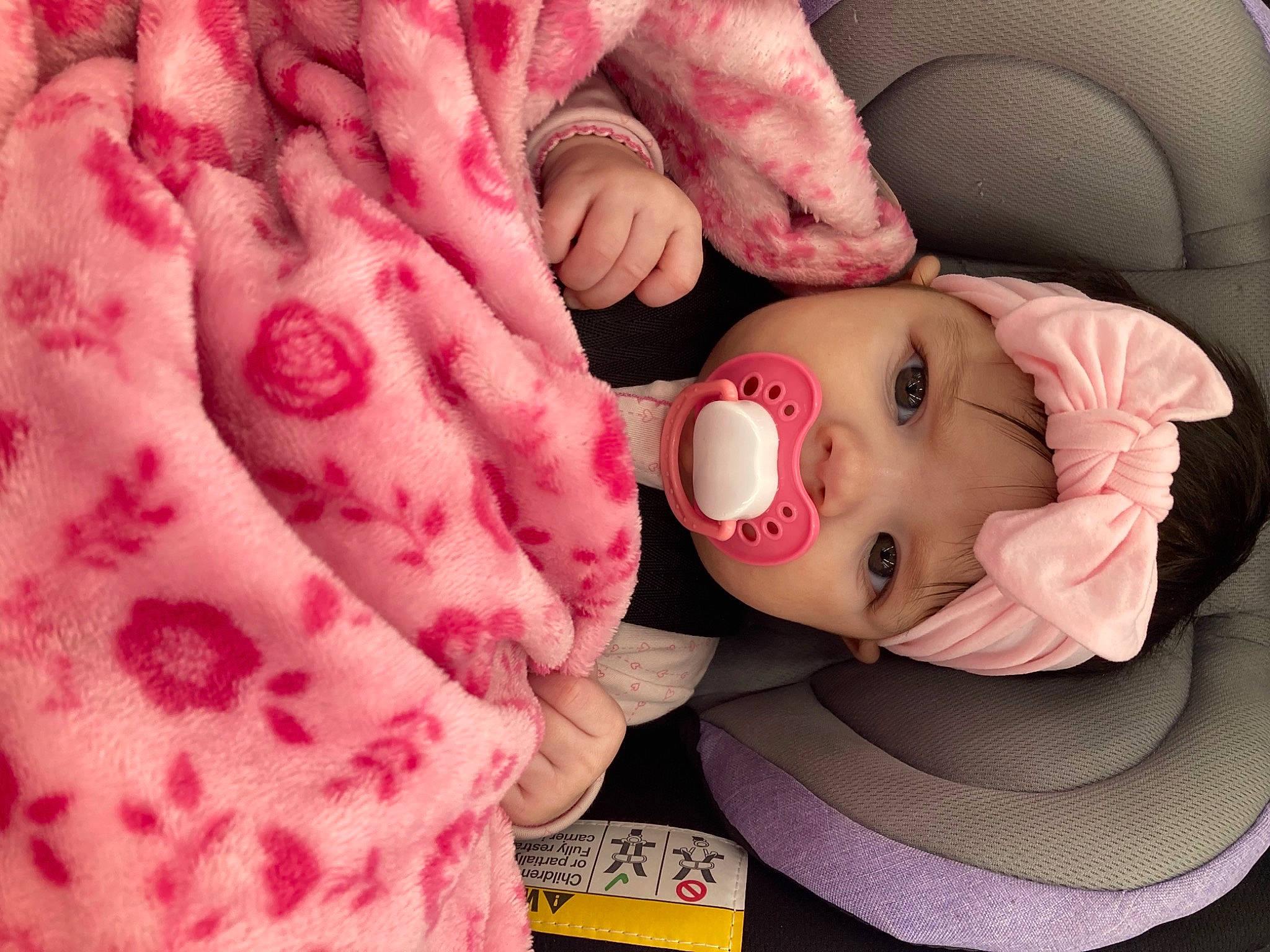 Braylynn is registered to the contest to win money with this photo: arm, baby, baby_toddler_clothing, cheek, chin, comfort, eye, eyebrow, eyelash, face, head, headwear, human_body, lip, mammal, mouth, nose, person, pink, skin