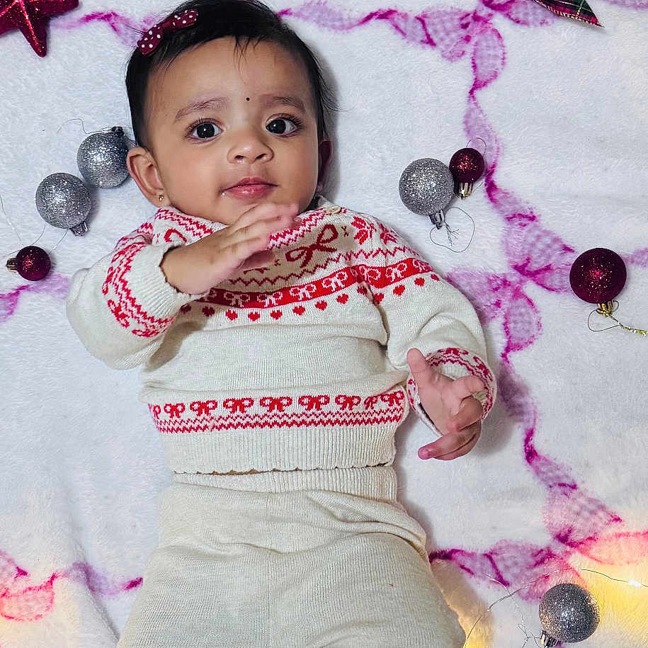 Issa joined the competition — help win amazing prizes! baby, blanket, brown, child, christmas, cozy, cute, decorations, face, holiday, infant, knitwear, lights, ornaments, plush, red, smiling, socks, toy, white