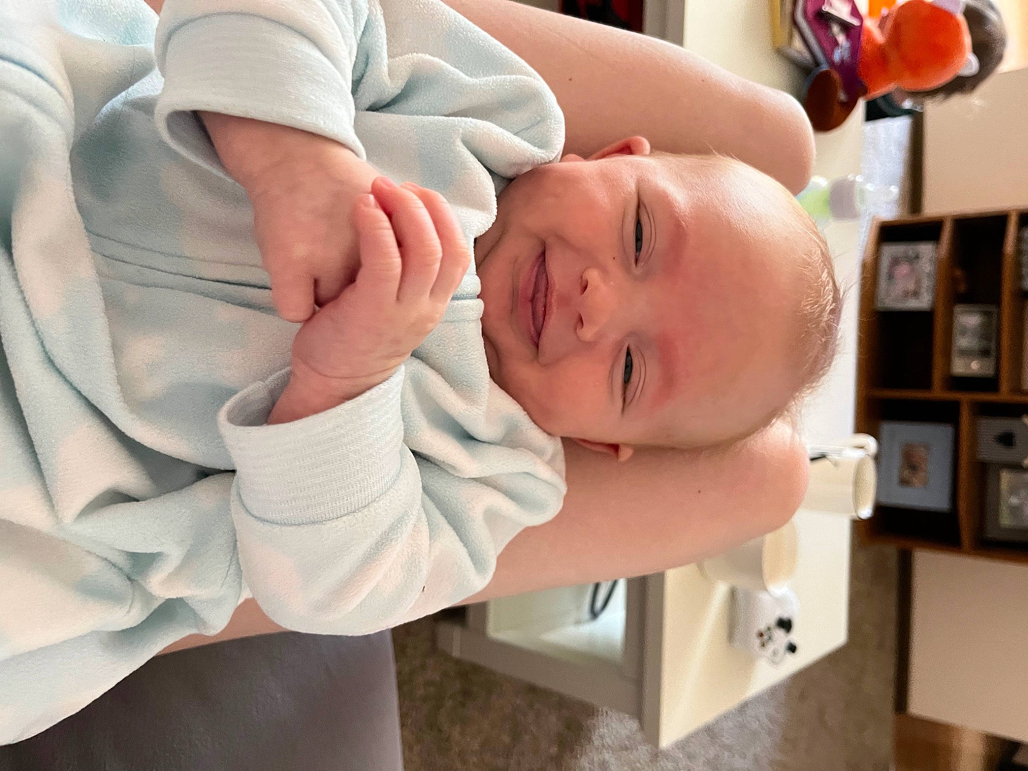 Alexander is registered to the contest to win money with this photo: abdomen, baby, baby_products, baby_toddler_clothing, bookcase, child, comfort, eyelash, finger, gesture, happy, hat, joy, nail, person, room, shelf, sleeve, smile, thumb