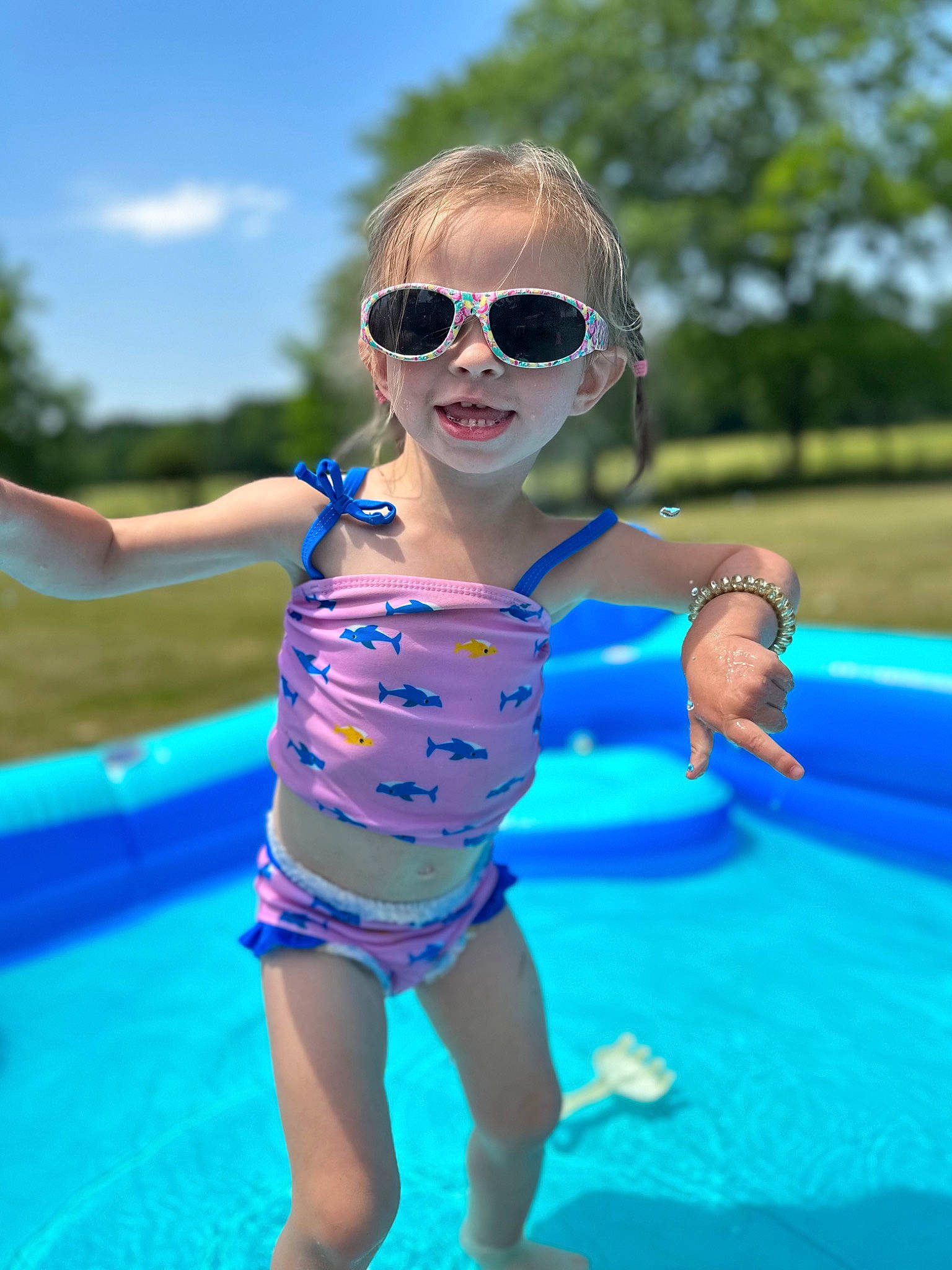 Journey is registered to the contest to win money with this photo: aqua, azure, electric_blue, eyewear, fun, goggles, grass, happy, leisure, one_piece_swimsuit, people_in_nature, person, recreation, sky, sunglasses, swimming_pool, swimwear, thigh, toddler, vision_care