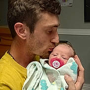 Leah Paige Henry is registered to the contest to win money with this photo: man, baby, newborn, pacifier, blanket, indoor, affection, love, holding, face, portrait, child, adult, close_up, family, parent, tenderness, care, skin, hair