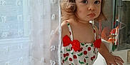Cataleya participe au concours pour gagner de l'argent avec cette photo : toddler, child, curtain, indoor, face, hair_accessory, red_bow, cherry_pattern, clothing, person, cute, serious_expression, window, white_curtain, light, home, skin, short_hair, standing, baby