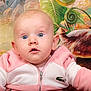 baby, child, pink_jacket, blue_eyes, curious_expression, portrait, indoor, colorful_background, plants, green_leaves, animal_figure, zipper, clothing, cute, infant, face, person, young_child, close_up, soft_lighting