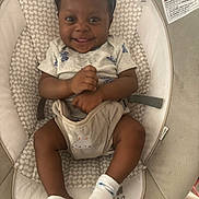 Elizabeth is registered to the contest to win money with this photo: baby, baby_seat, child, clothing, comfort, cushion, cute, face, hands, happy, headband, indoors, infant, legs, pattern, person, seatbelt, skin, smiling, socks