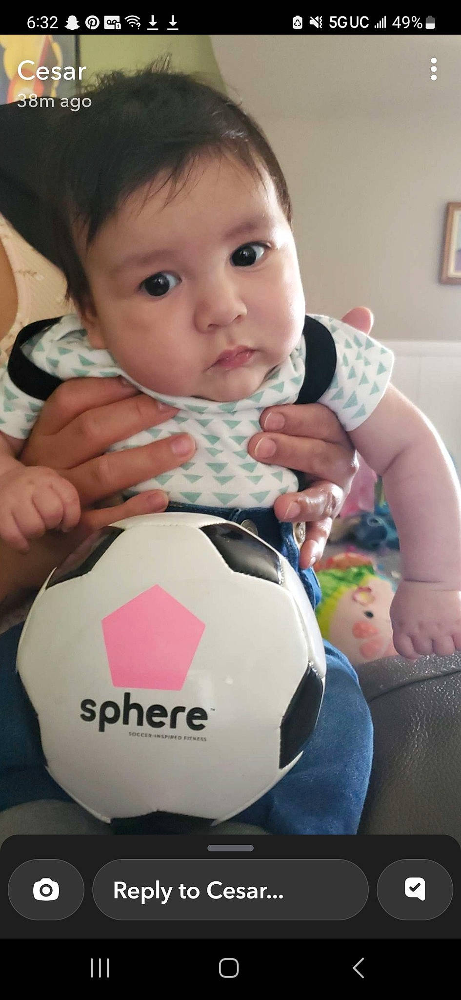 Castiel is registered to the contest to win money with this photo: baby, baby_toddler_clothing, child, facial_expression, finger, football, fun, hand, happy, human, nail, person, picture_frame, product, sitting, skin, sleeve, soccer, t_shirt, thumb