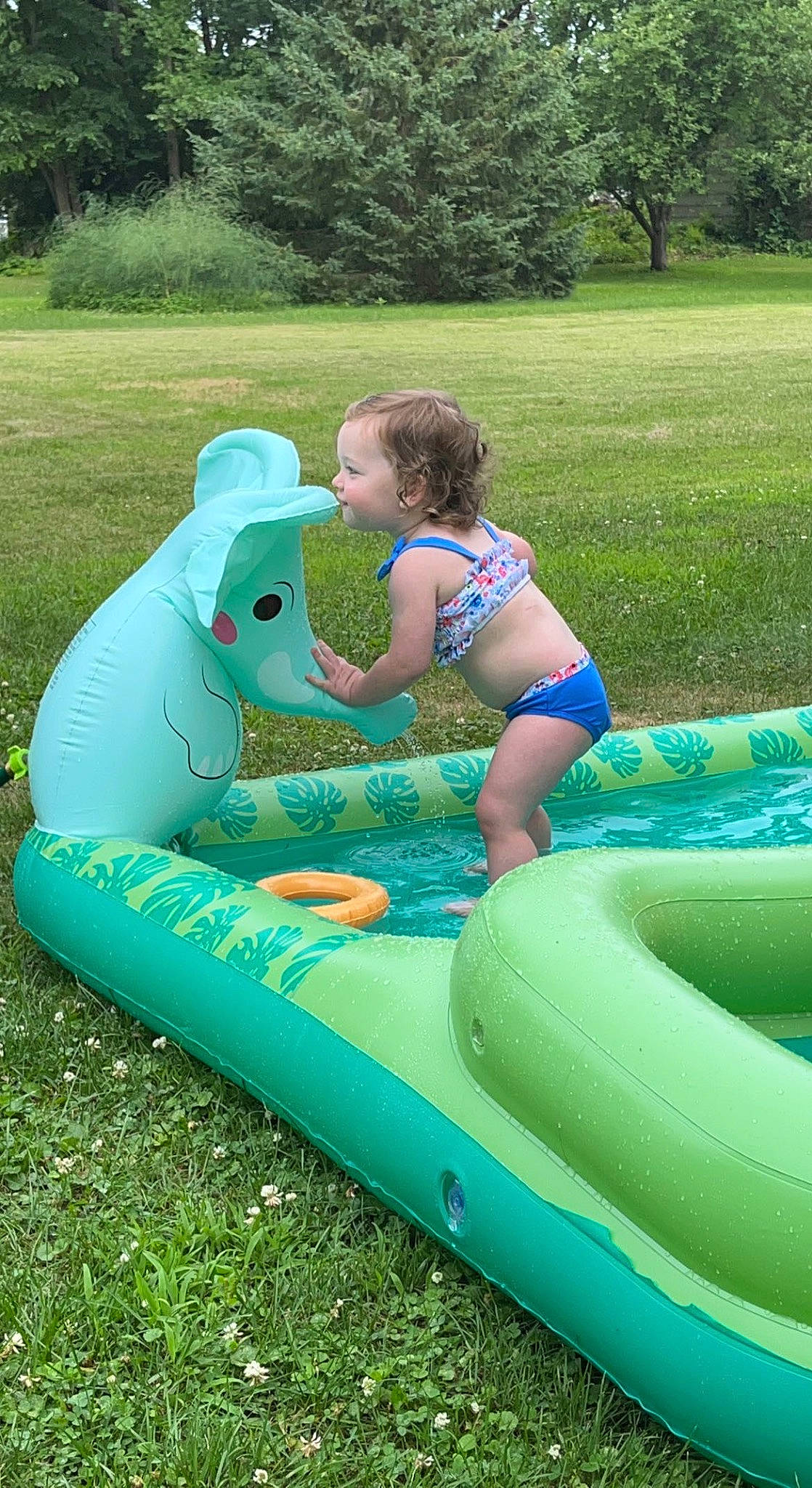 Rhilynn joined the competition — help win amazing prizes! aqua, boats_and_boating_equipment_and_supplies, bounce_house, fun, games, grass, green, happy, inflatable, leisure, nonbuilding_structure, outdoor_recreation, people_in_nature, person, plant, play, recreation, swimwear, toddler, tree