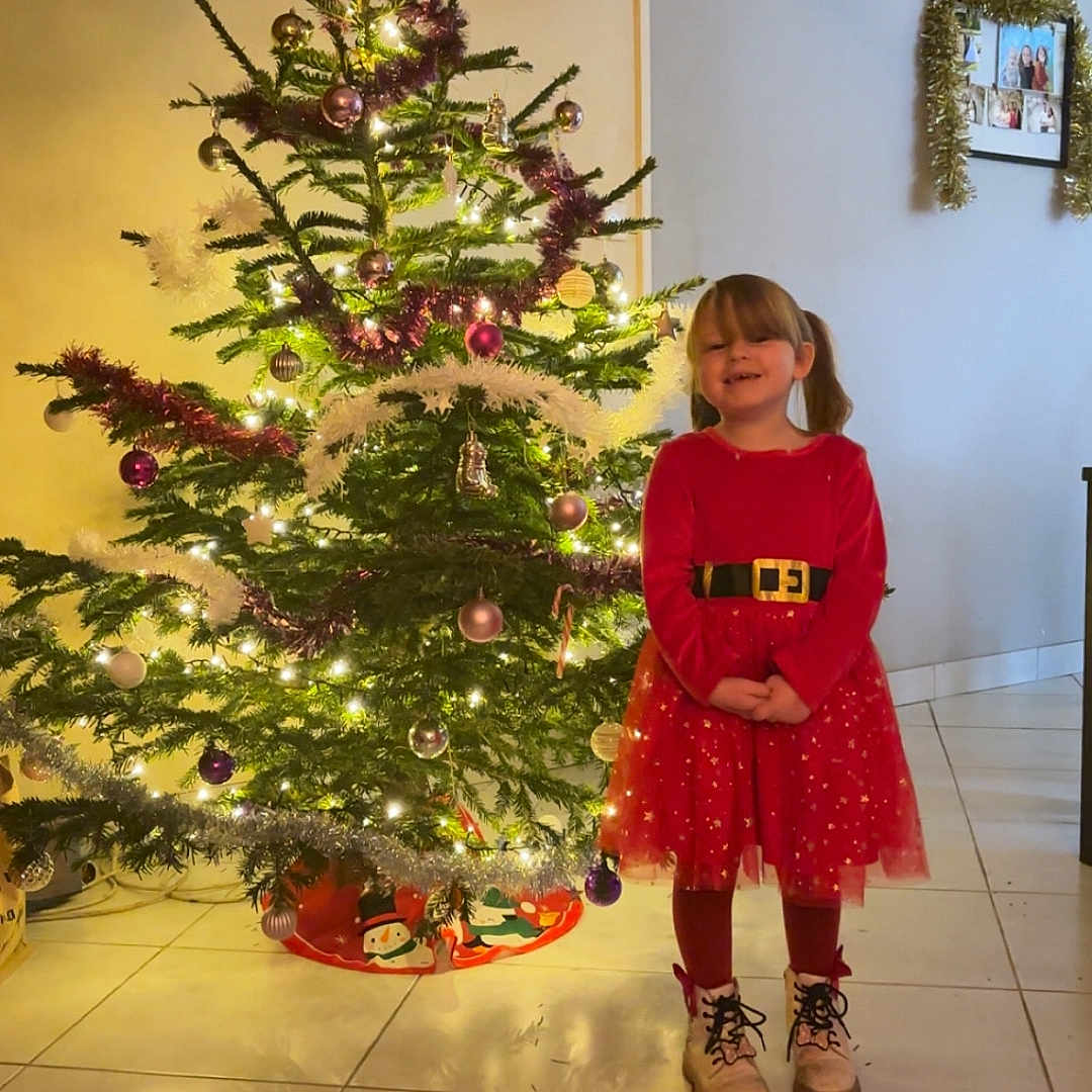 Louise a rejoint le concours — aidez-le/la à gagner de superbes lots ! child, christmas, clothing, coat, dress, face, female, fir, flower, flowerarrangement, footwear, girl, head, person, photography, plant, portrait, pottedplant, shoe, tree