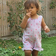 Thaïs participe au concours pour gagner de l'argent avec cette photo : toddler, child, grass, garden, plants, flowers, wooden_fence, outdoor, barefoot, romper, pink_polka_dot, snack, curious, young_child, greenery, summer, daylight, nature, portrait, small_child
