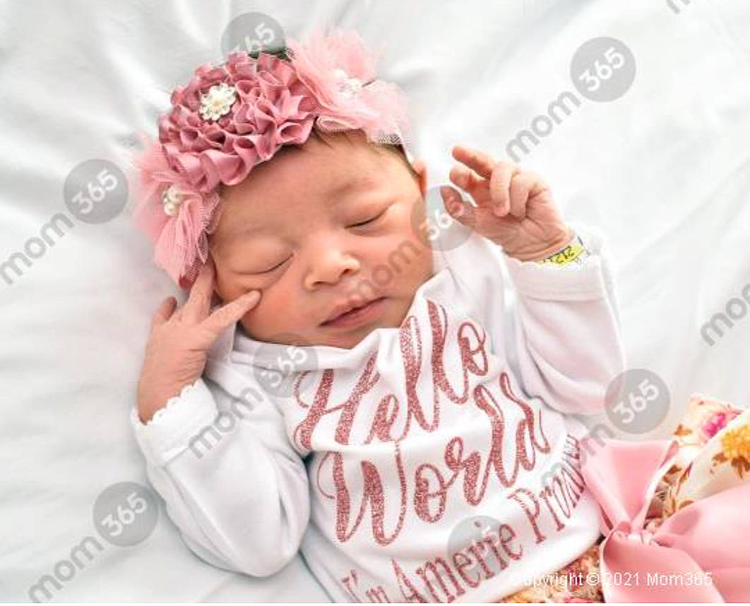 Amerie is registered to the contest to win money with this photo: baby, baby_toddler_clothing, cap, cheek, child, chin, eyebrow, eyelash, face, finger, flower, font, happy, headpiece, headwear, lip, person, petal, pink, skin