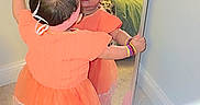 Miral joined the competition — help win amazing prizes! balloons, bracelet, carpet, celebration, child, curtain, decoration, full_length_mirror, happy, headband, indoor, mirror, orange_dress, party, reflection, room, smile, toddler, wall, window