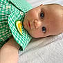 Rose a rejoint le concours — aidez-le/la à gagner de superbes lots ! apparel, arm, baby, blue_eyes, checkered_pattern, child, closeup, cute, expression, face, green_clothing, infant, lemon_patch, lying_down, person, portrait, skin, soft_light, white_background, young_child