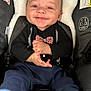 baby, baby_clothes, blue_eyes, bow_tie, car_seat, casual, child, clothing, cute, happy, indoors, infant, infant_smile, plush_headrest, portrait, seatbelt, sitting, smiling, tuxedo_outfit, young_child