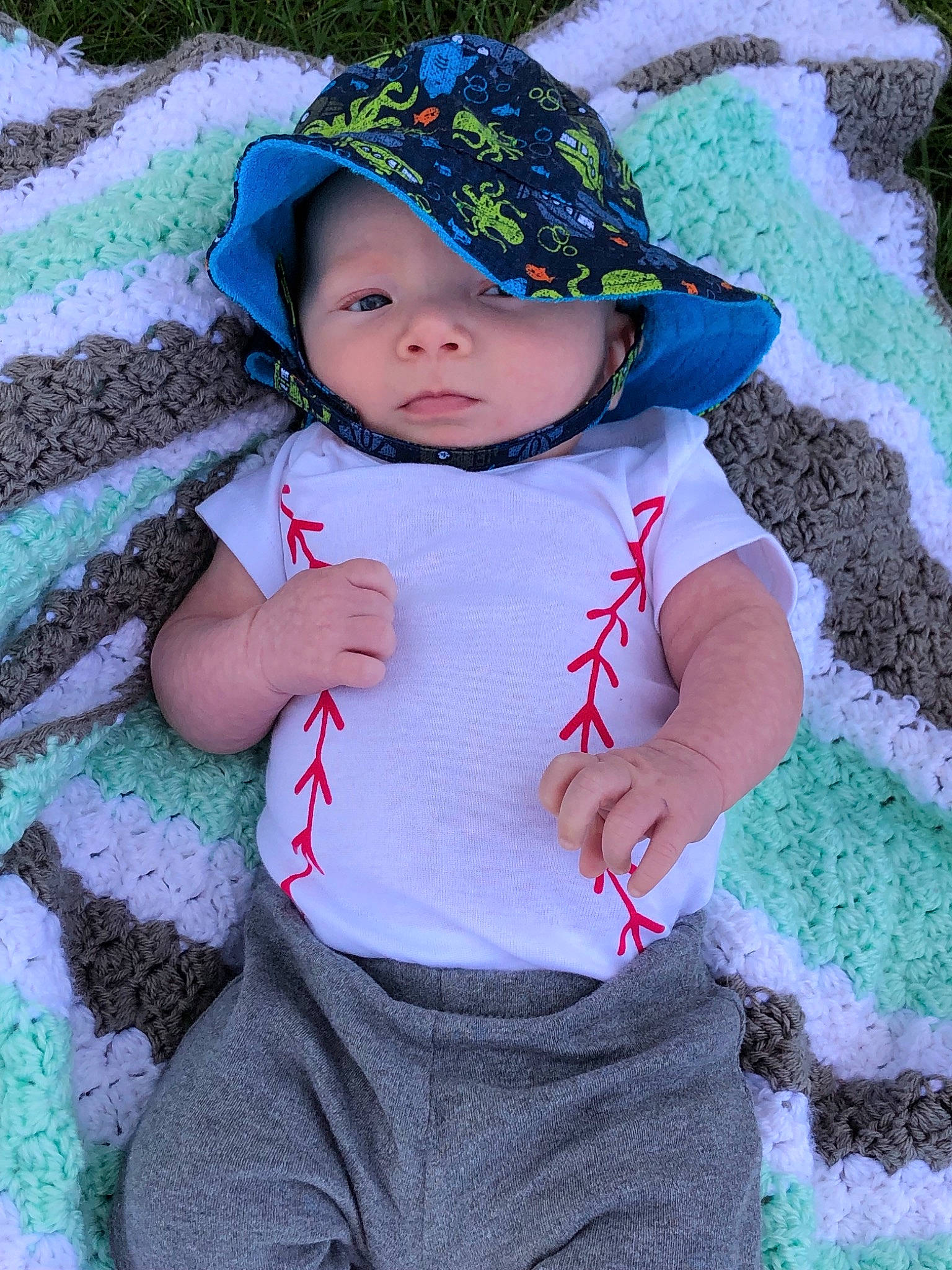 Tyler is registered to the contest to win money with this photo: baby, baby_products, baby_toddler_clothing, bonnet, cap, child, clothing, costume_accessory, fashion_accessory, hat, headgear, pattern, person, play, skin, smile, sun_hat, toddler
