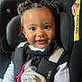 Inaya participe au concours pour gagner de l'argent avec cette photo : baby, black, blanket, car_seat, child, closeup, clothing, cute, face, hair, happy, indoors, infant, pacifier, person, portrait, safety, seatbelt, smiling, white