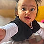baby, bed, black_vest, blanket, child, closeup, clothing, curious, cute, expression, eyes, face, hair, hand, indoor, portrait, skin, toddler, white_shirt, young