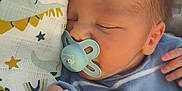 Kaiis participe au concours pour gagner de l'argent avec cette photo : newborn, baby, sleeping, pacifier, blanket, blue_clothing, hand, face, cozy, infant, cute, patterned_cloth, stars, animal_print, soft_texture, resting, indoors, closeup, peaceful, child