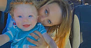 Jeston is registered to the contest to win money with this photo: baby, child, woman, car, seat, blue_eyes, smile, holding, portrait, people, happy, casual, indoor, closeup, family, toddler, blond_hair, clothing, hand, timestamp