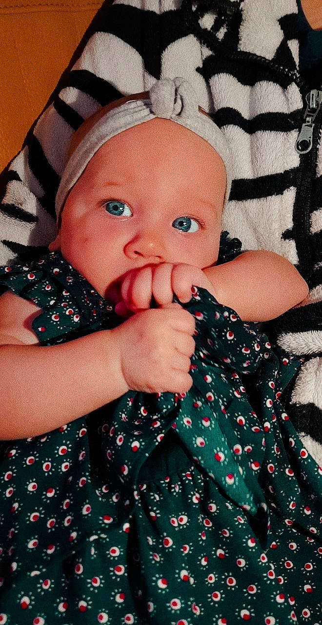 Harper participe au concours pour gagner de l'argent avec cette photo : baby, baby_toddler_clothing, cheek, child, design, eye, face, finger, hand, head, lip, mouth, nail, nose, pattern, person, polka_dot, skin, textile, toddler